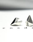 Edgy Gold Heart Studs in white gold by Bena Jewelry, featuring a geometric heart design, photographed on a soft pastel background, modern unisex jewelry custom-made in Montreal.