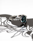6. Hexagonal Sapphire Platinum Ring worn on hand – A stunning engagement ring with an electric blue sapphire, designed for those who seek bold and unique fine jewelry.