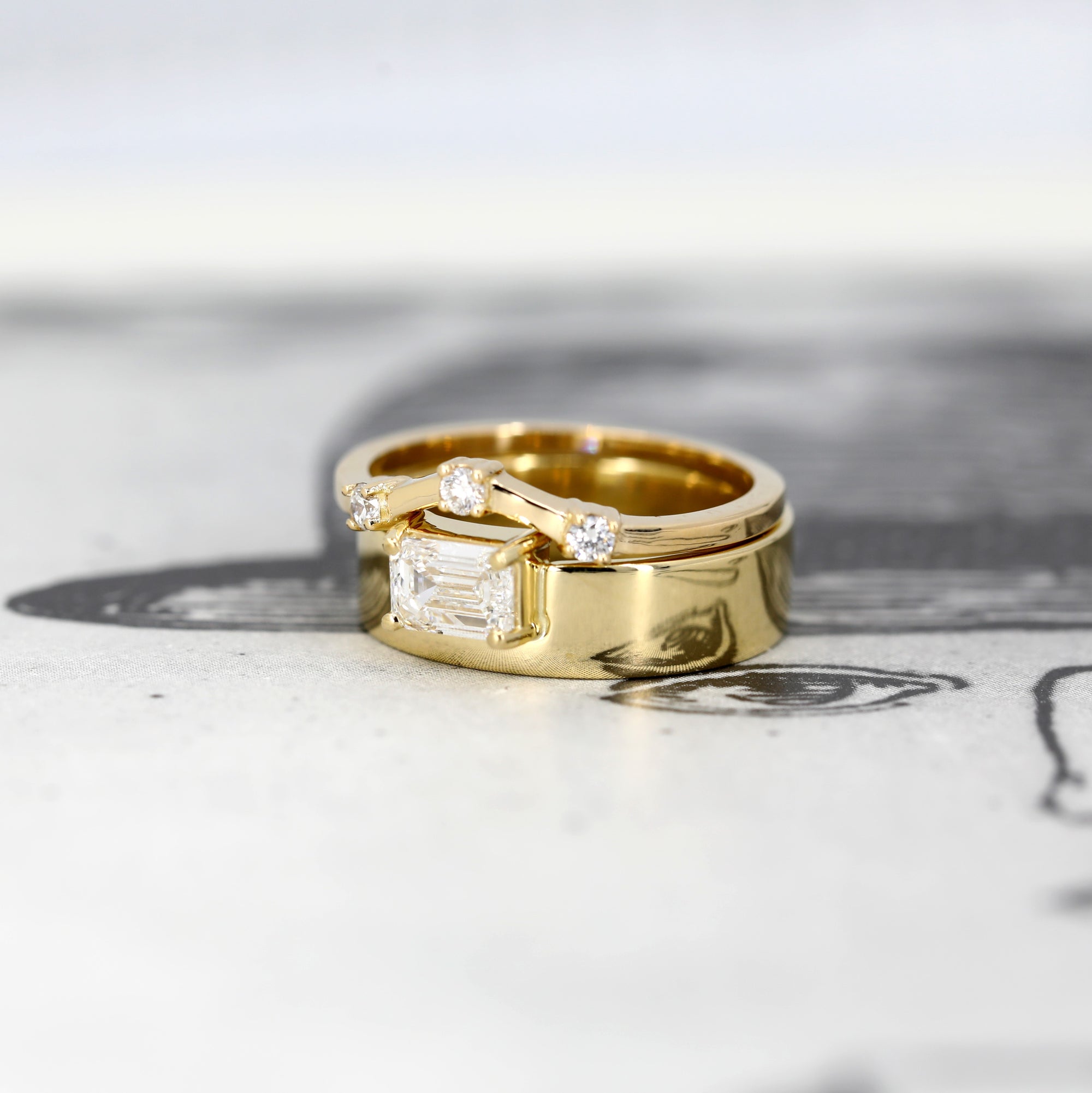 Elegant yellow gold ring featuring a prominent emerald-cut diamond and minimalist design. A contemporary creation by Bena Jewelry, made in Montreal.