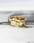 Elegant yellow gold ring featuring a prominent emerald-cut diamond and minimalist design. A contemporary creation by Bena Jewelry, made in Montreal.
