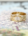 Modern yellow gold engagement ring with a prominent emerald-cut diamond and sleek, bold lines. Designed and made by Bena Jewelry, Montreal-based jewelry designer.