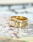 Wide yellow gold band with an emerald-cut diamond centerpiece. Contemporary and edgy fine jewelry by Bena Jewelry, crafted in Montreal, Canada.