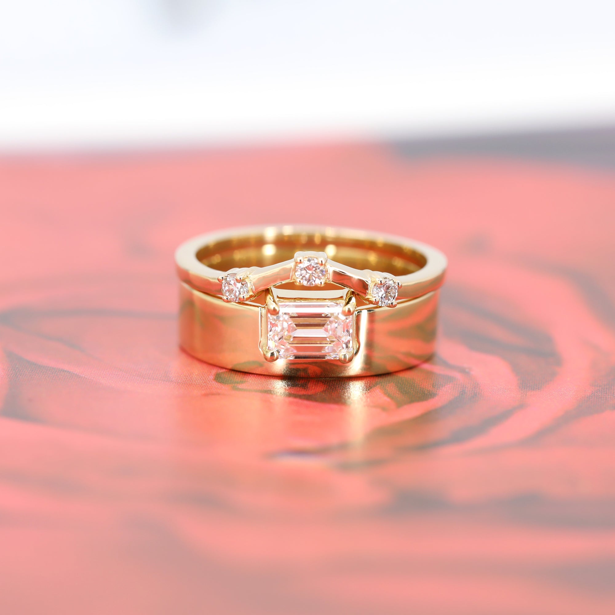 Elegant engagement ring in yellow gold with a large emerald-cut diamond, showcasing a bold and minimalist design. Made in Montreal by Bena Jewelry.