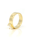 Edgy yellow gold engagement ring showcasing an emerald-cut diamond and a substantial gold design. A fine jewelry piece by Bena Jewelry, made in Montreal.