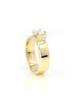Close-up of a contemporary yellow gold engagement ring with an emerald-cut diamond. Designed and crafted in Montreal by Canadian jeweler Bena Jewelry.