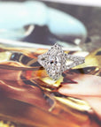 front view of lab grown marquise shape diamond engagement ring custom made in montreal by bena jewelry on multi color background