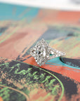 side view of marquise shape lag grown diamond and halo custom made engagement ring montreal by bena jewelry on multi color background