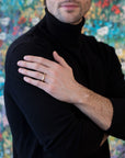 men wearing a chiseled men ring custom made in montreal by bena jewelry designer on multi color background