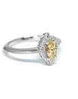Close-up of the yellow marquise diamond engagement ring, showcasing its halo setting and elegant design. Made in Canada.