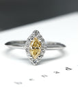 The Aura Ring, a custom-made vintage-inspired engagement ring, beautifully displayed on a soft-colored background.