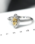 Detailed view of the marquise-cut yellow diamond and halo, an elegant engagement ring made in Montreal, Canada.