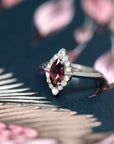Side view of edgy bridal ring marquise shape red garnet gemstone engagement ring white diamonds small round white gemstone natural maquise garnet red gems custom made in montreal handemade in canada fine jewelry designer