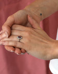 Girl wearing bena jewelry fine jewelry edgy bridal ring marquise shape rhodolite garnet ring with small white rond diamonds handmade in montreal canada