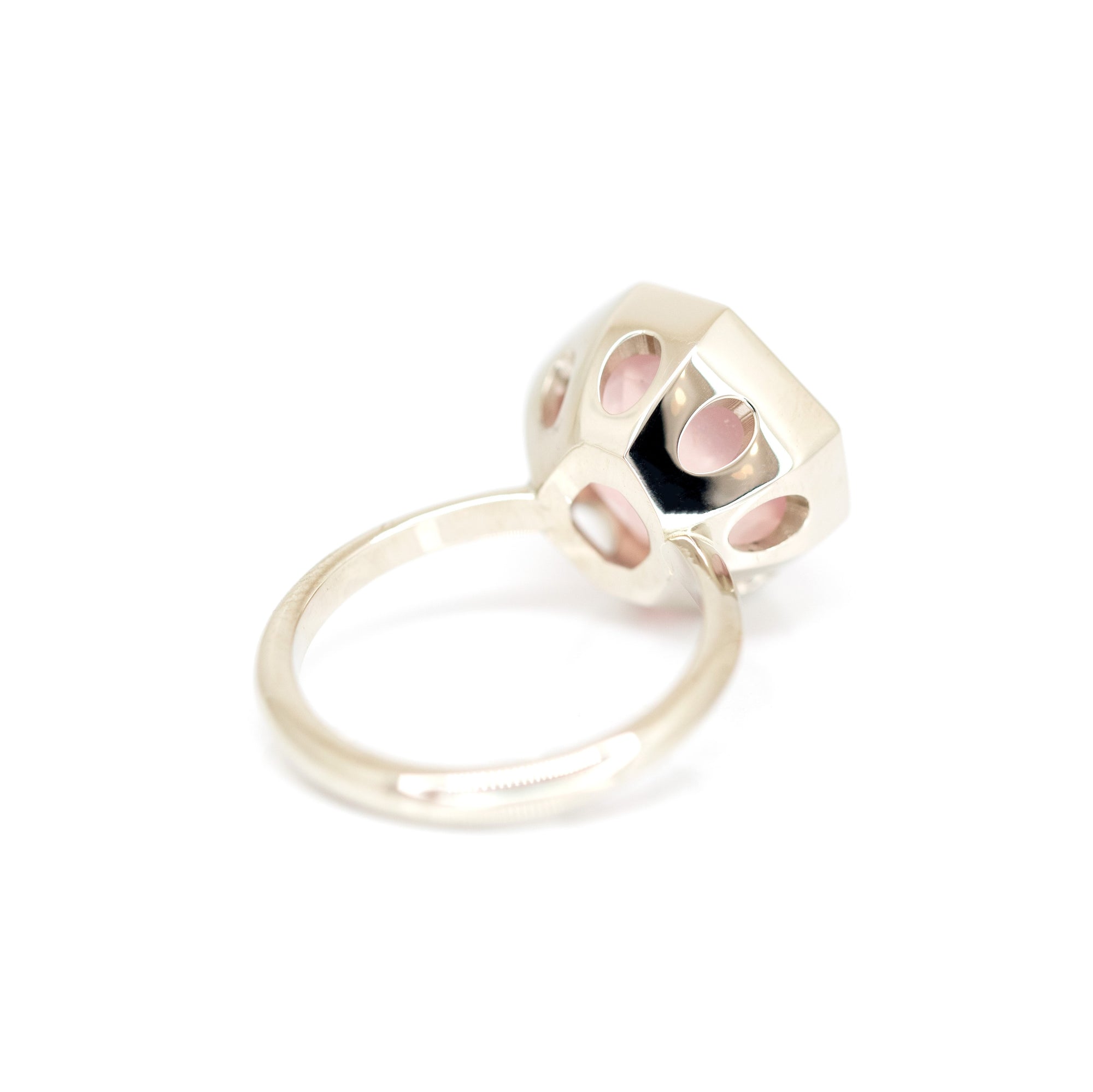 Back view of a unique rose quartz statement ring in white gold by Bena Jewelry, photographed on a white background, fine jewelry custom-made in Canada.