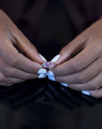 A model wearing the Avalanche Pink Sapphire Ring in an elegant setting, emphasizing its vibrant gemstones and luxurious design. Custom-made by Bena Jewelry in Montreal, Canada.