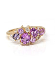 Close-up: Focuses on the vibrant pink and violet hues of the sapphires and the sparkle of the diamonds against the yellow gold. Made by Bena Jewelry, Montreal, Canada.