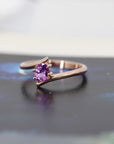 front view of pink sapphire engagament ring cusotm made in montreal by bena jewelry on black and white background