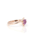 side view of oval shape pink sapphire rose gold twist band kink ring made in montreal by bena jewelry designer on white background