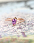 front view of pink sapphire custom made engagement ring made in montreal by bena jewelry on multi color background