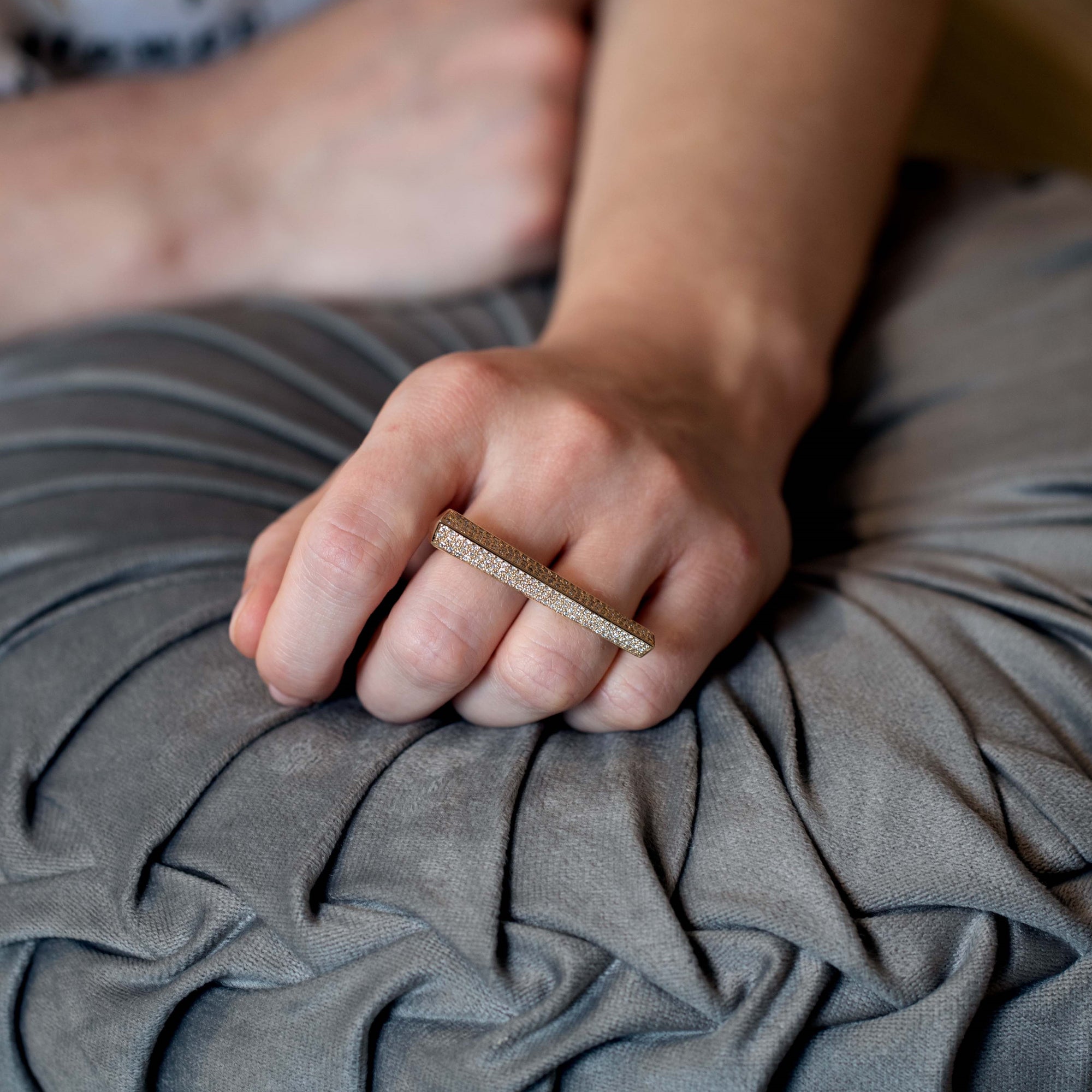 A model wearing the Punch Diamond Ring, displaying its striking two-finger design and shimmering diamond pavé. Made by Bena Jewelry in Montreal, Canada.