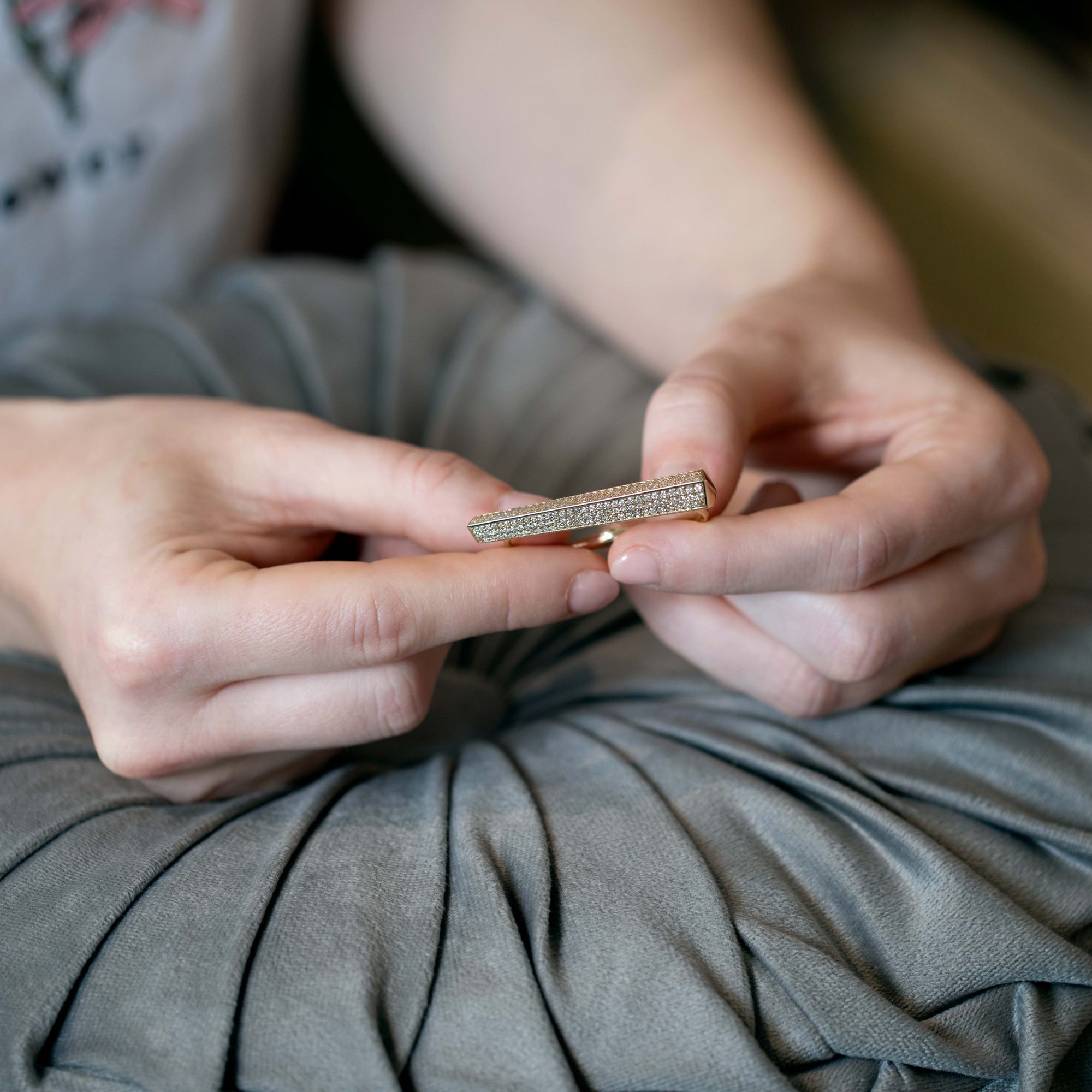 Side angle of the Punch Diamond Ring on a model's hand, highlighting the substantial gold volume and unique two-finger structure. Designed by Bena Jewelry in Montreal, Canada.