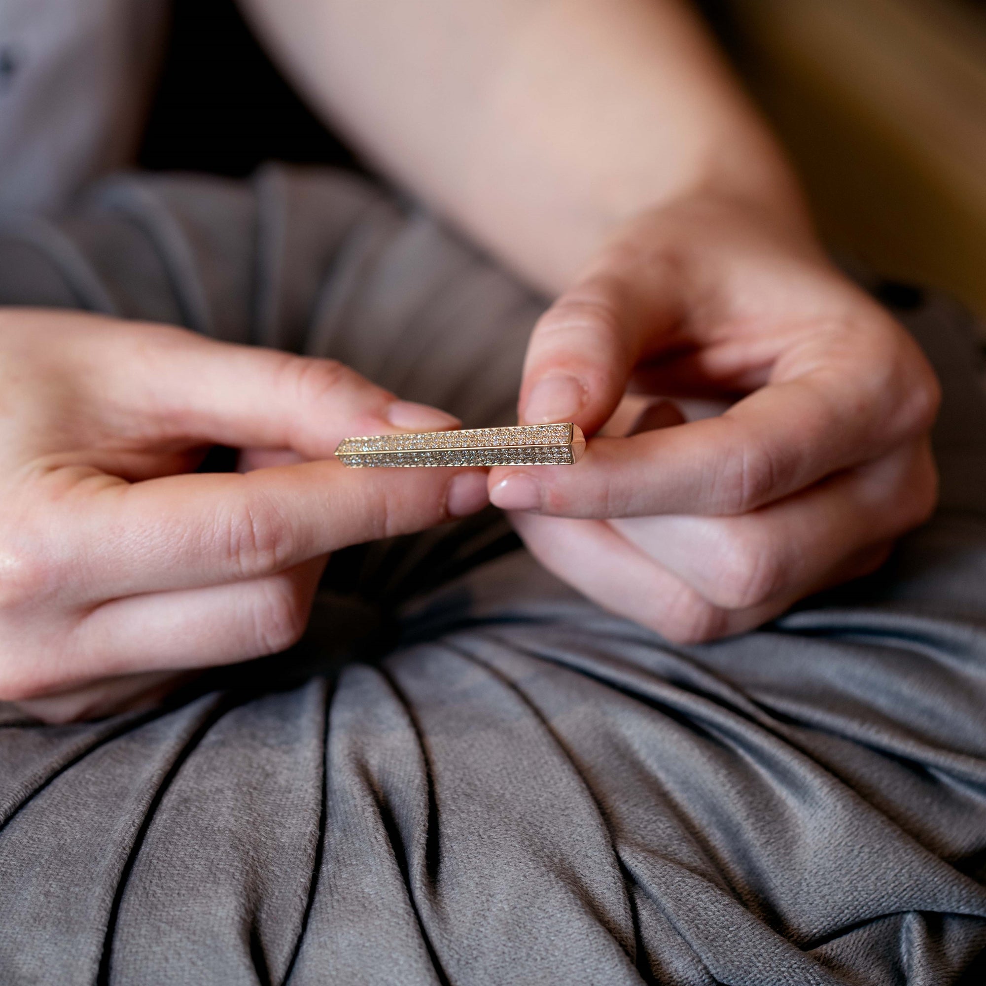 Side angle of the Punch Diamond Ring on a model's hand, highlighting the substantial gold volume and unique two-finger structure. Designed by Bena Jewelry in Montreal, Canada.