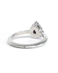 Top-down perspective of the Aura engagement ring, featuring a luminous pear-shaped pink-violet sapphire in a halo of sparkling diamonds. Handmade by Bena Jewelry, designer in Montreal, Canada.