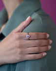 The Aura ring shines on a woman’s hand, emphasizing its graceful pear-cut sapphire and delicate diamond details.