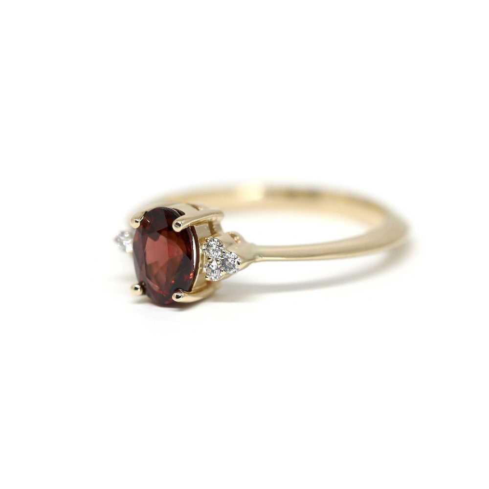 Side view of a yellow gold Désir Pyrope Garnet Ring by Bena Jewelry featuring a natural gemstone and diamonds photographed on a white background bespoke wedding jewelry