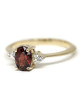 Classic yellow gold bridal ring with a vibrant pyrope garnet centerpiece and diamond accents by Bena Jewelry displayed on a white background fine jewelry made in Canada