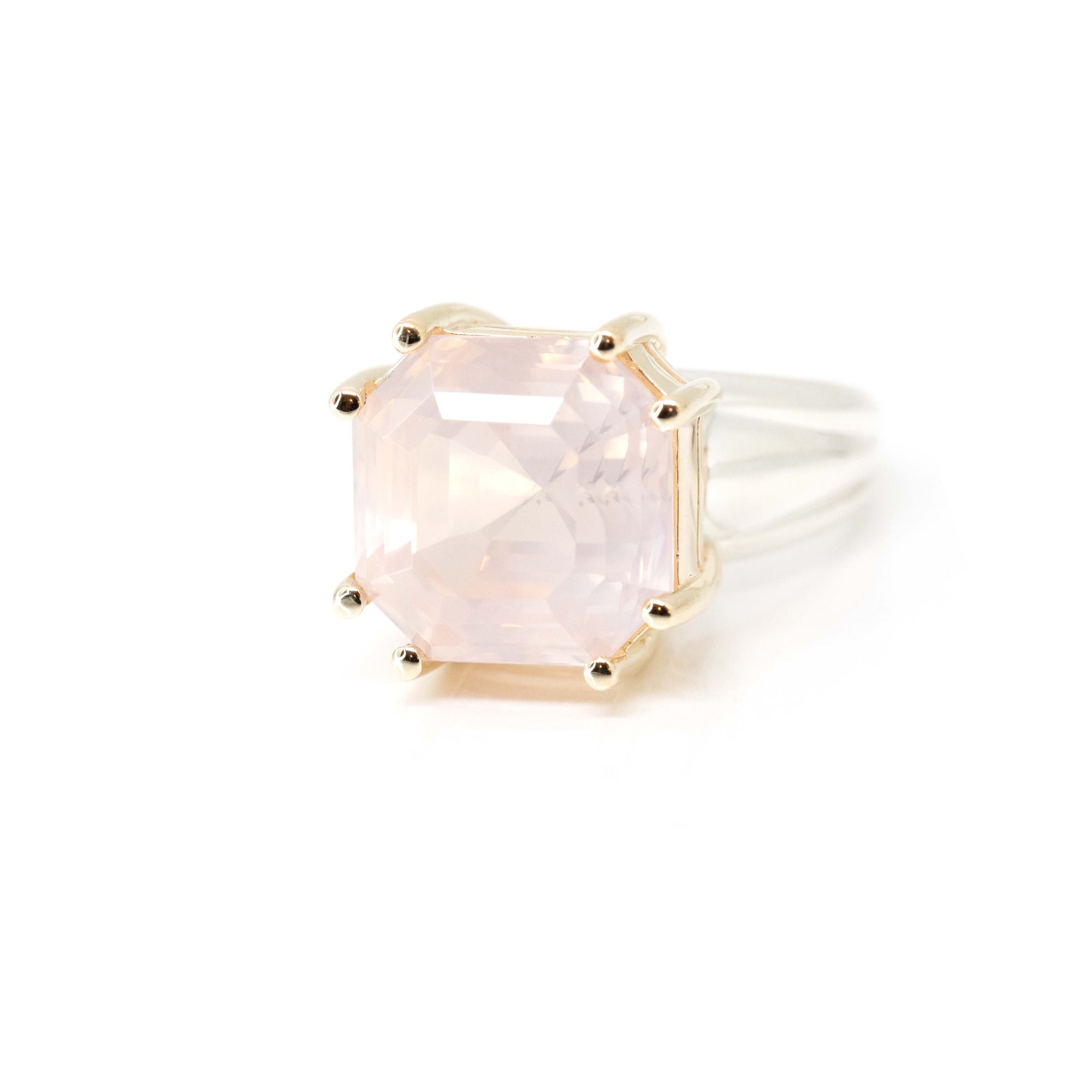 6. Rose Quartz Ring on soft-toned background – The translucent pink quartz glows warmly against the contrast of mixed metals, creating a unique fine jewelry piece.