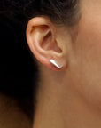 Lifestyle shot of Pike Earrings worn – A refined statement earring that combines minimalism with an edgy aesthetic.