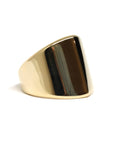 Close-up of boxy gold ring – A sleek and modern geometric ring, featuring a structured, solid gold design with a refined finish.