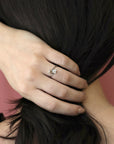 Double Cushion Diamond Ring worn on hand, close-up – A refined Toi et Moi engagement ring featuring a white and brown cushion-cut diamond in white gold. Handmade by Bena Jewelry in Montreal.