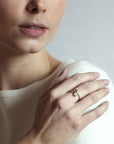 Toi et Moi ring on soft-toned background – The warm brown diamond and brilliant white diamond create a striking contrast.