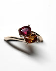 Side view of colorful Toi et Moi ring – The contrast between the fiery garnet and deep ruby enhances the ring’s bold elegance.
