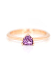 this bridal ring is made with a trillion shape purple rhodolite garnet by bena jewelry designer on a white back ground