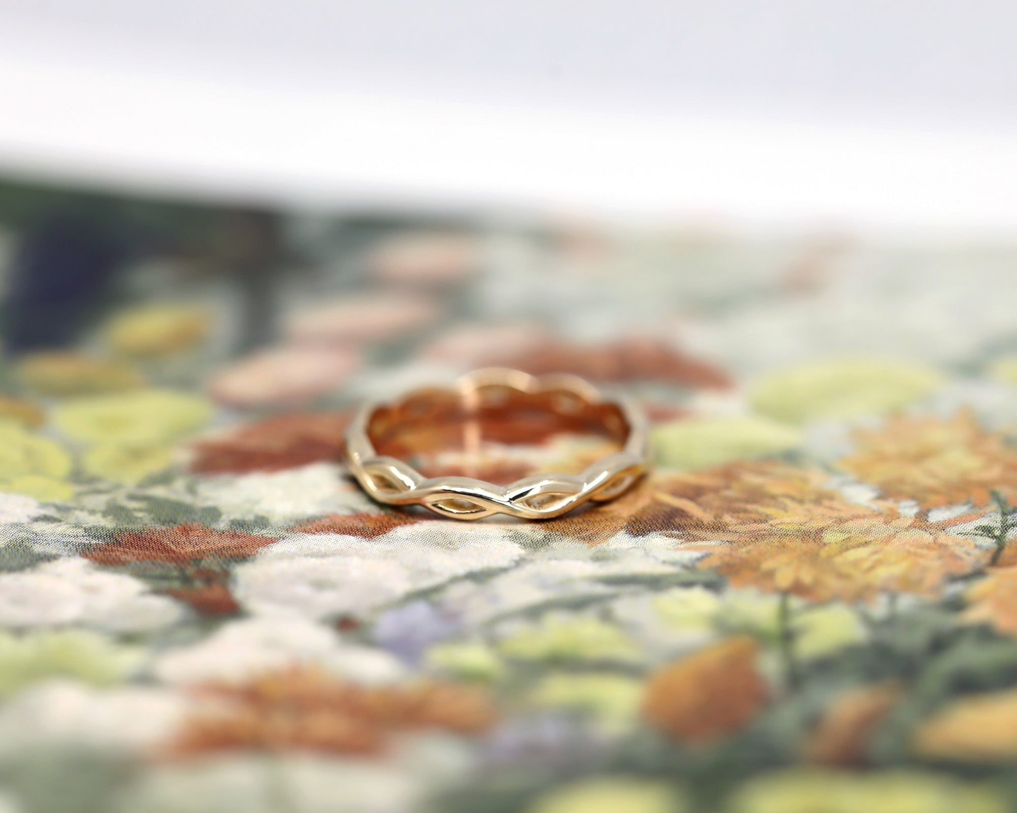 Angled shot of Braided Ring in Yellow Gold – A sleek and delicate wedding ring designed for daily wear.