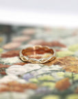 Angled shot of Braided Ring in Yellow Gold – A sleek and delicate wedding ring designed for daily wear.