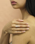 Close-up of girl wearing Peak Ring in White Gold – A refined and powerful unisex ring with a sharp, elongated structure.