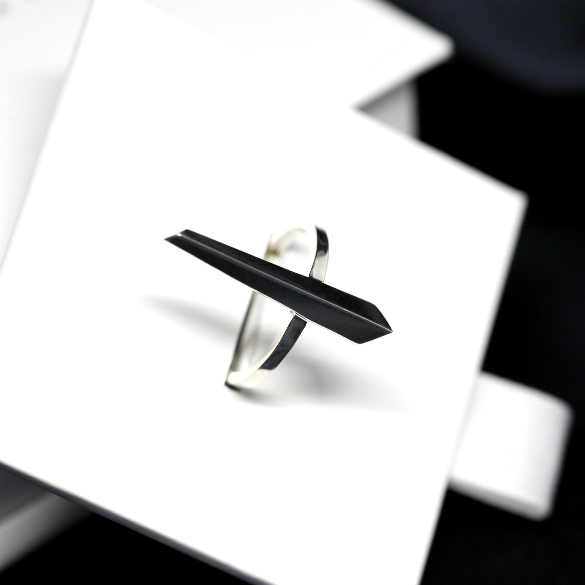 Angled shot of Peak Ring in White Gold – A contemporary and structured gold ring with a distinctive elongated design.