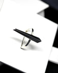 Angled shot of Peak Ring in White Gold – A contemporary and structured gold ring with a distinctive elongated design.