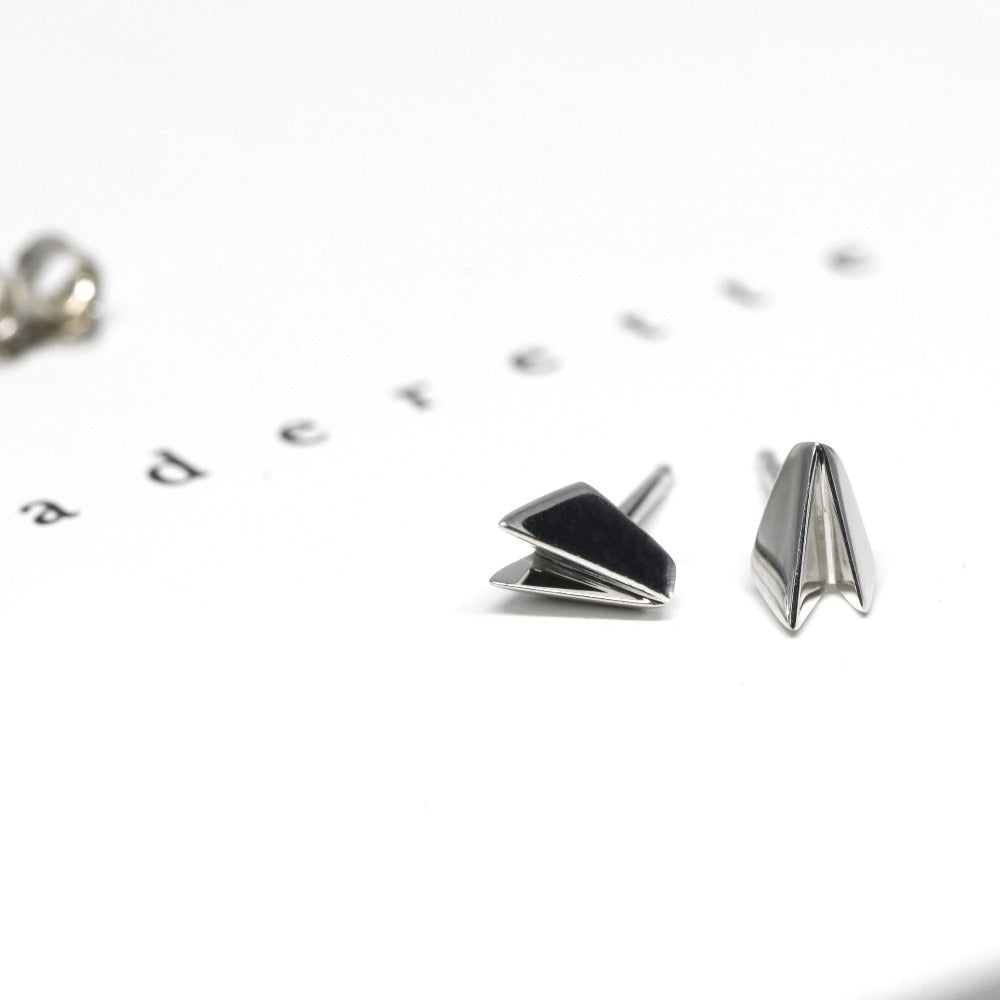 Edgy white gold stud earrings by Bena Jewelry, featuring a geometric minimalist design, displayed on a plain white background custom-crafted in Montreal