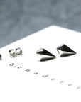 Mini Spade Gold Stud Earrings worn on ear, close-up – Small and modern, these discreet white gold studs add a refined touch to any look. Designed by Bena Jewelry in Montreal.