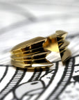 Angled shot of Crush Ring in Yellow Gold – A sculptural unisex ring with a refined yet daring presence, designed by Bena Jewelry.
