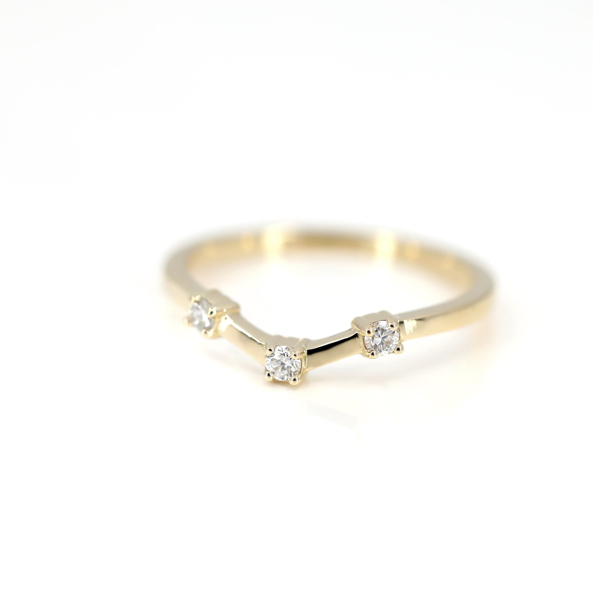 Close-up of a sleek yellow gold wedding band featuring round diamonds and a bold boxy style. Fine contemporary jewelry by Bena Jewelry, handcrafted in Montreal.