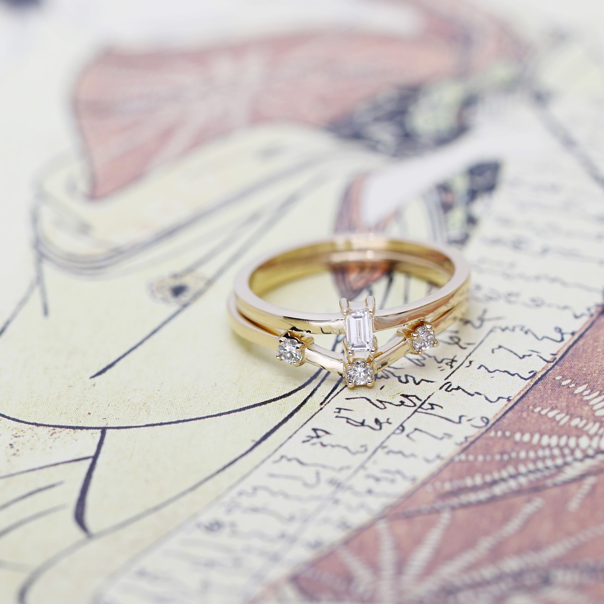 Yellow gold wedding band with a modern boxy design and round diamonds, showcased on a vibrant background. Contemporary fine jewelry by Bena Jewelry, crafted in Montreal.