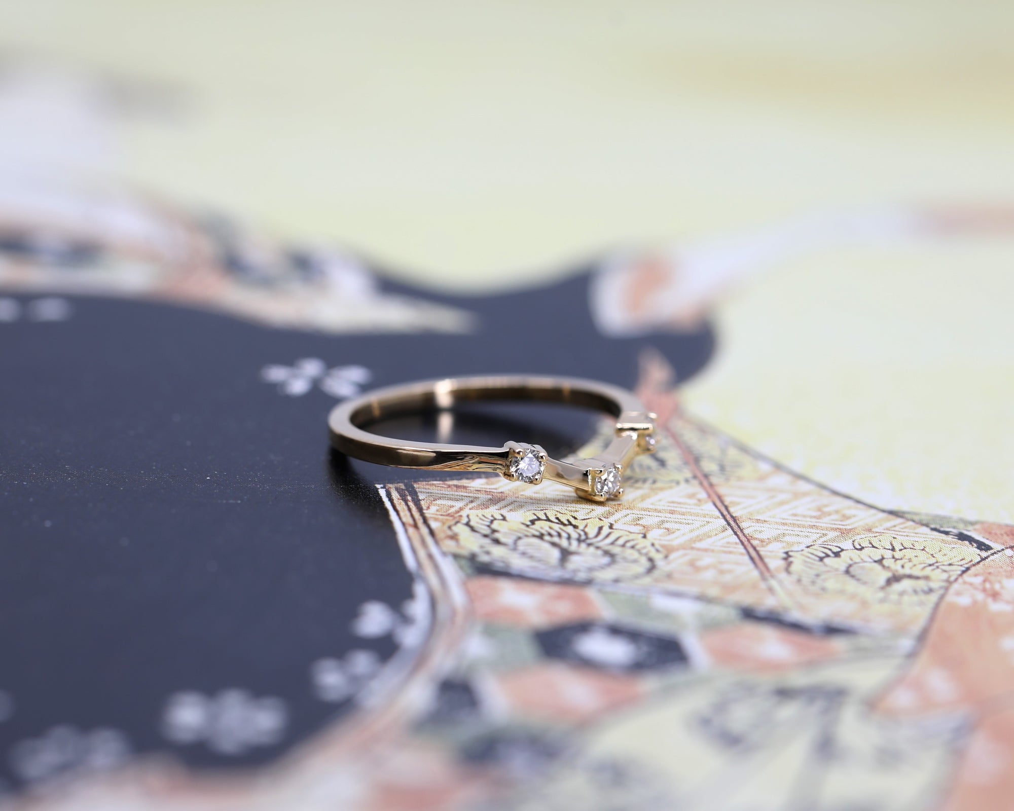Elegant yellow gold wedding band with round diamonds in a geometric boxy design. Perfect for pairing with diamond engagement rings. Designed by Bena Jewelry, made in Montreal.