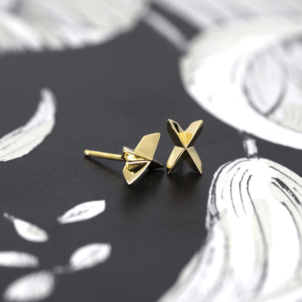 Cross Gold Studs in yellow gold featuring a voluminous cross design by Bena Jewelry, photographed on a dark background, custom unisex jewelry made in Montreal.