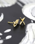 Cross Gold Studs in yellow gold featuring a voluminous cross design by Bena Jewelry, photographed on a dark background, custom unisex jewelry made in Montreal.